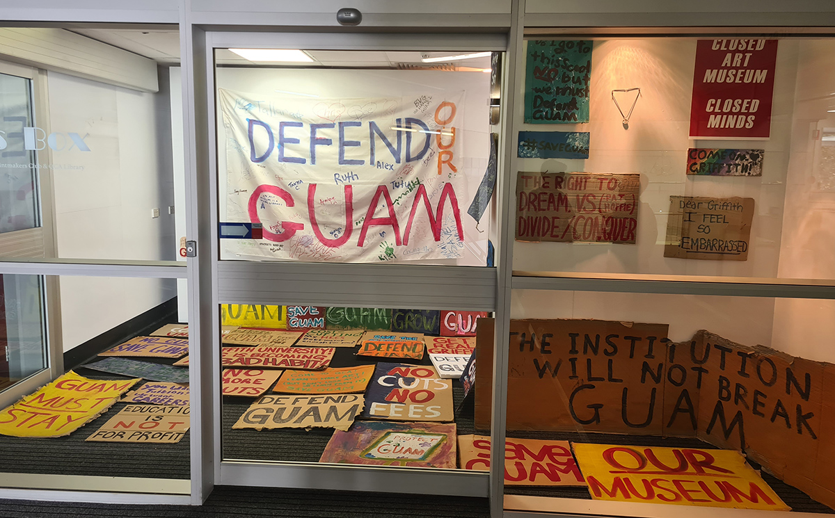 Handmade protest signs in a glass-fronted office